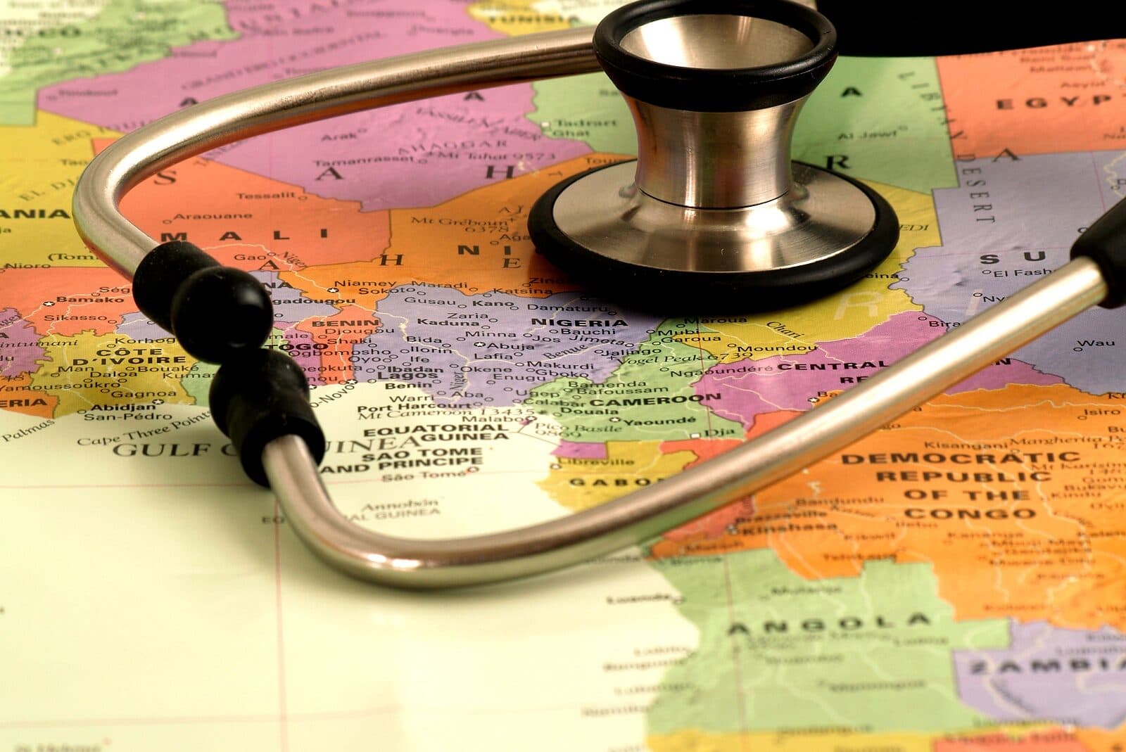 A stethoscope rests on a colorful map of Africa.