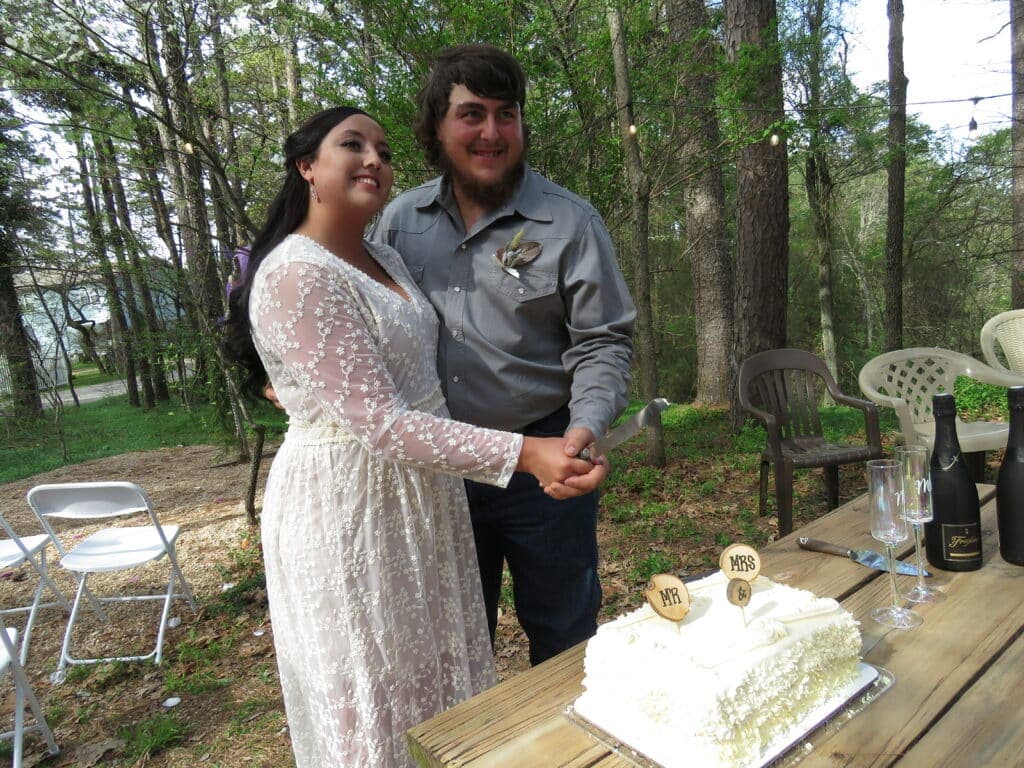 bride and groom cutting wedding cake