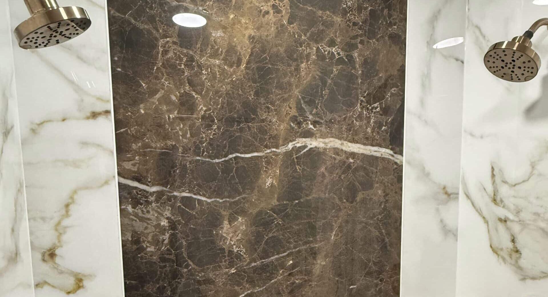 Walk in shower with marble walls and double brushed gold shower heads