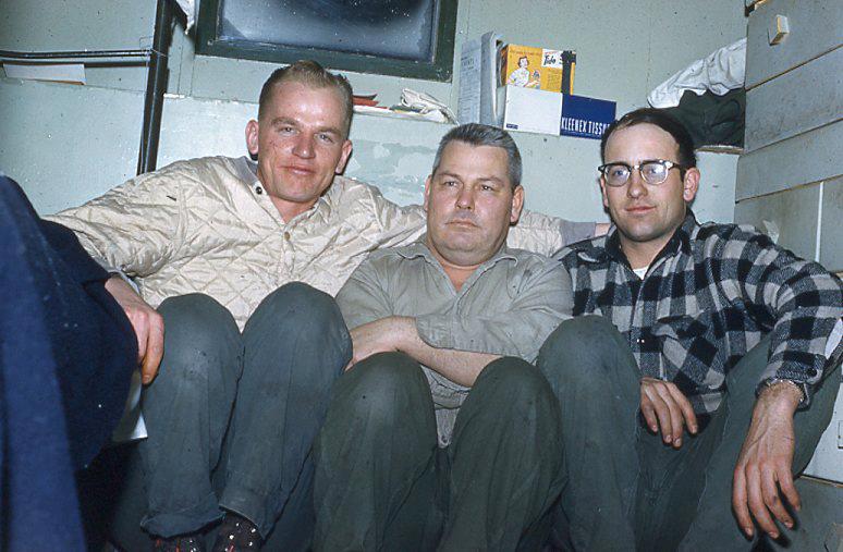 Three men sitting together for a picture