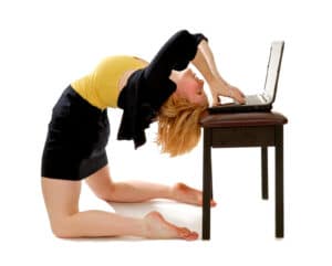 Business women bending over backwards at a computer