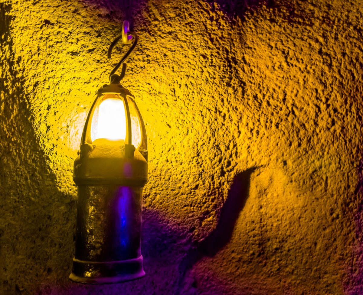 Lantern with a spooky yellow glow on a concrete wall