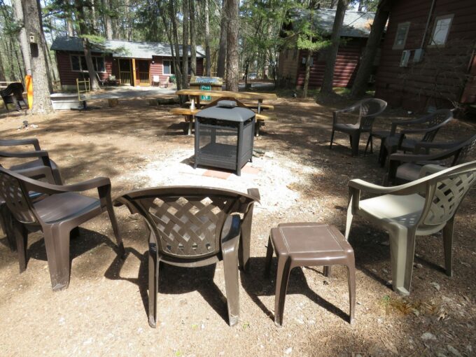 Gathering area around a fire pit with chairs around it