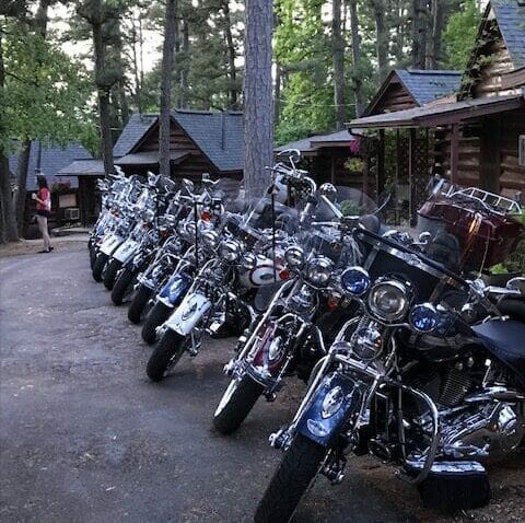 Motorcycles parked in front of historic cabins at Tall Pines Inn eureka springs ar