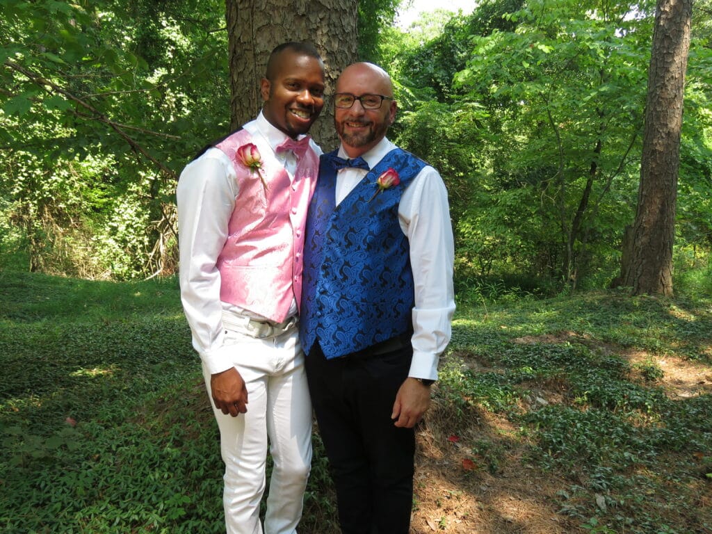 groom and groom preparing for their wedding standing in front of a tree