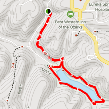 hiking trail marked in red around a lake