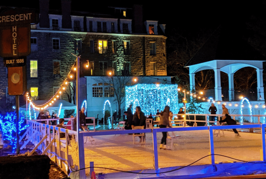 Outdoor ice skating rink with people skating